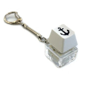 Mechanical keyboard switch keycap keychain with black anchor symbol and metal chain