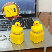 Yellow duck-shaped speakers on laptop keyboard with rechargeable USB port shown in inset